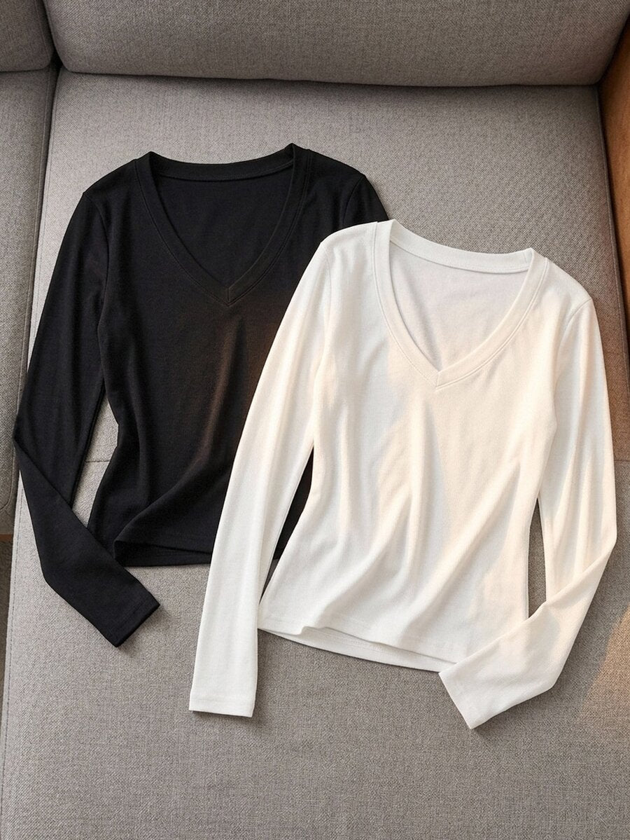 Women's fitted long sleeve rib-knit top featuring a deep V-neckline with delicate contrast lace detailing.
