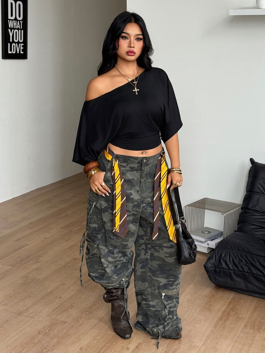 Black plus size cropped knit t-shirt featuring an asymmetrical scoop neckline, three-quarter batwing sleeves, and a loose casual fit.