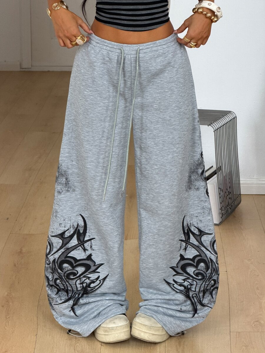 Women's loose fit wide leg graphic sweatpants in light grey with an elastic drawstring waistband