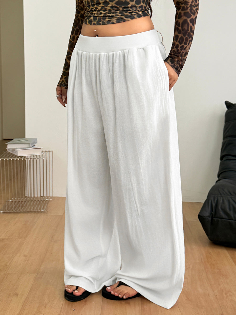 Plus size women's striped loose straight leg cropped pants with pleated detailing and side pockets