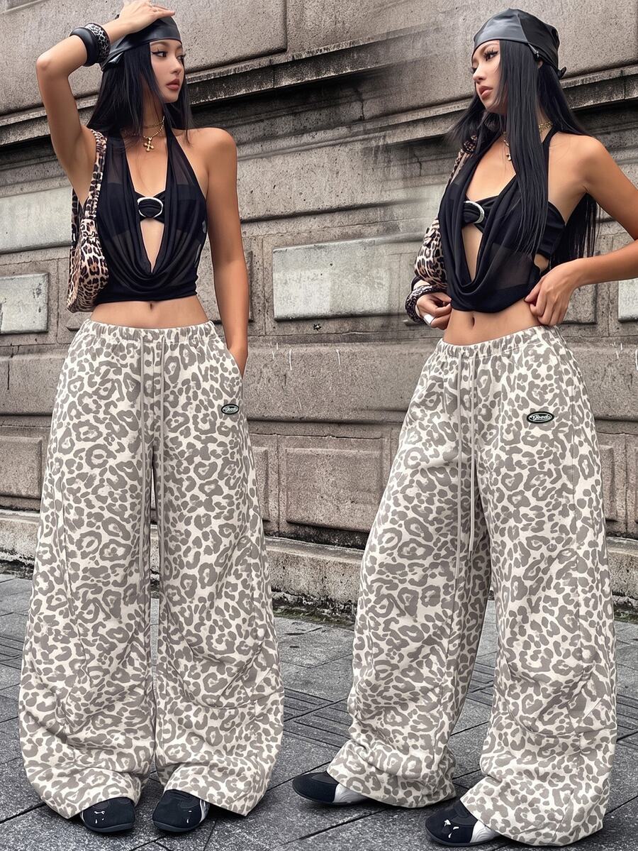 Women's black baggy jogger pants with an adjustable drawstring waist and colorblock polka dot geometric pattern.
