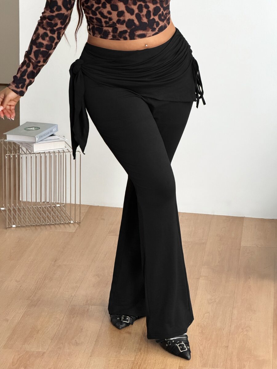 Women's striped flare leg pants featuring a mid-rise waist, slim fit thigh, and ruched side drawstring detail in stretch knit fabric.