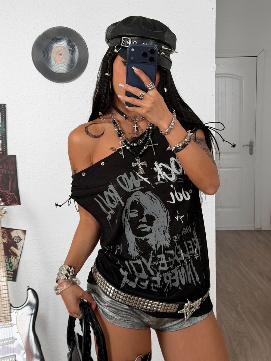 Black plus size cold shoulder graphic T-shirt featuring grommet eyelets, asymmetrical knot detail, and batwing cap sleeves.