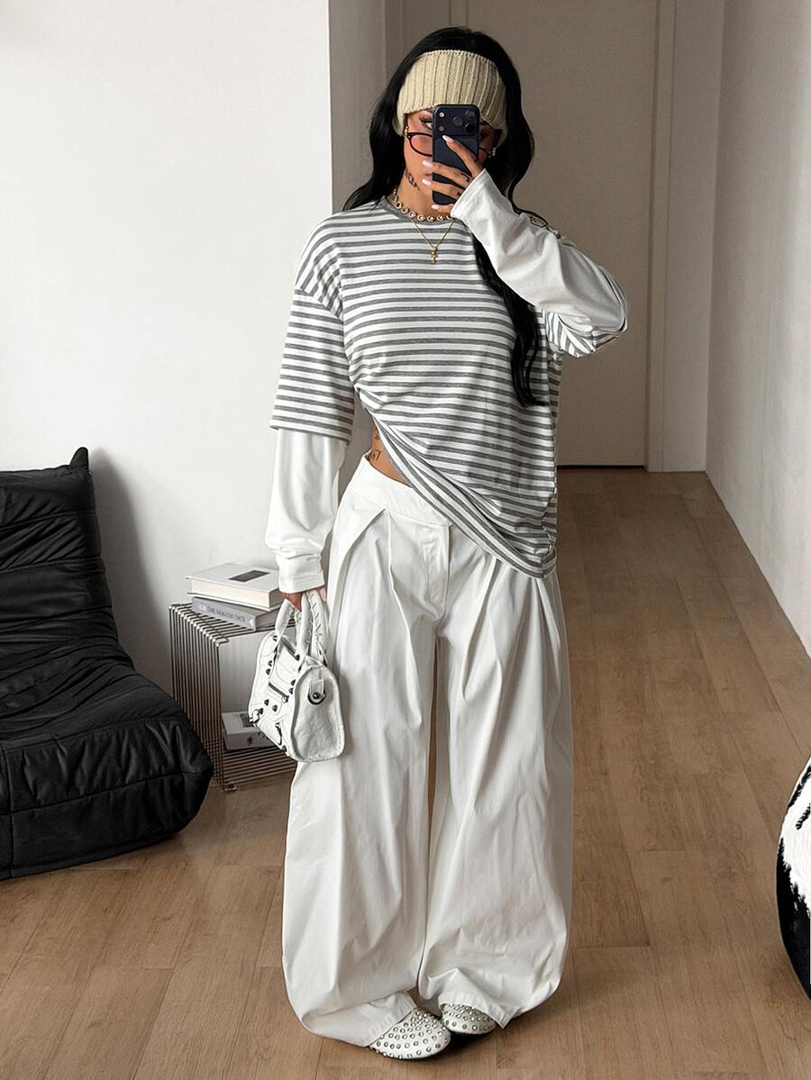 Women's casual graphic long sleeve t-shirt with a round neck, drop shoulder sleeves, and loose relaxed fit.