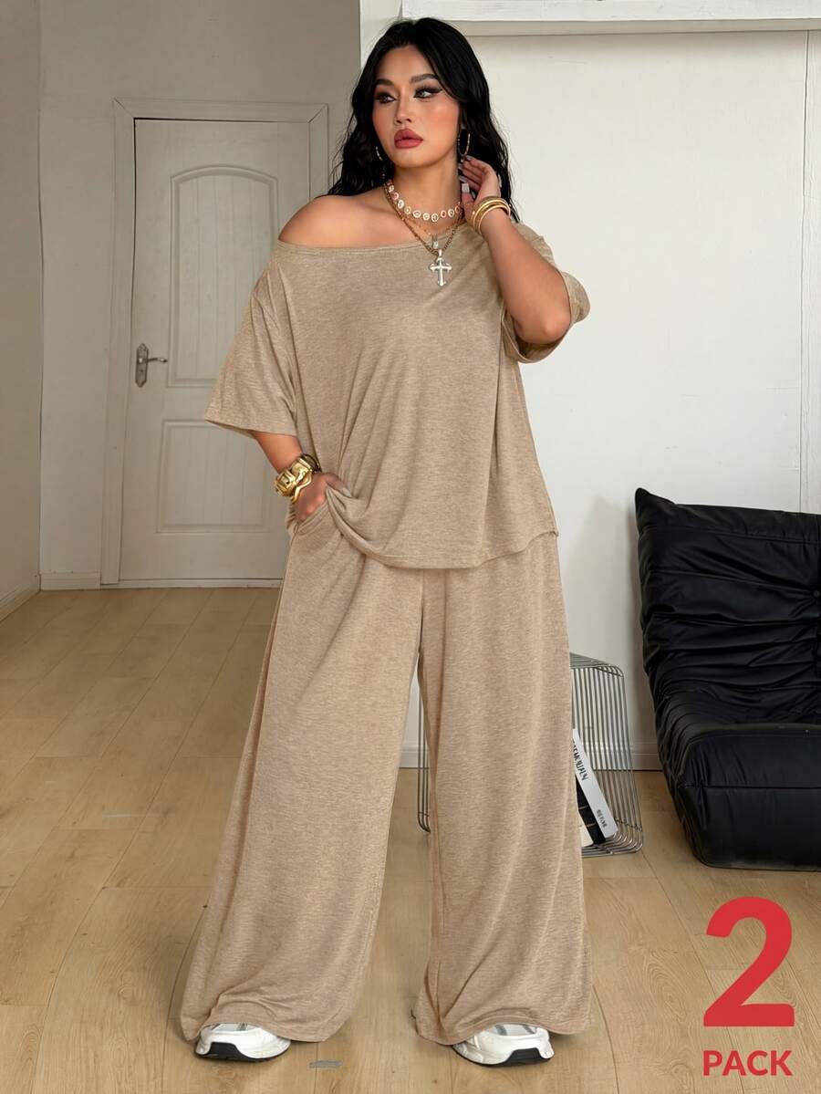 Women's casual two-piece outfit featuring a loose short-sleeve asymmetrical neck t-shirt and matching long wide leg pants with pockets.