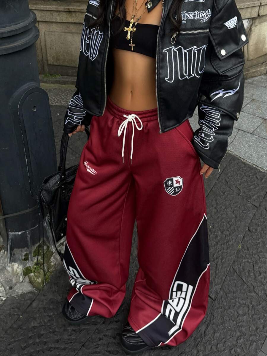 Women's loose fit wide leg graphic sweatpants in light grey with an elastic drawstring waistband