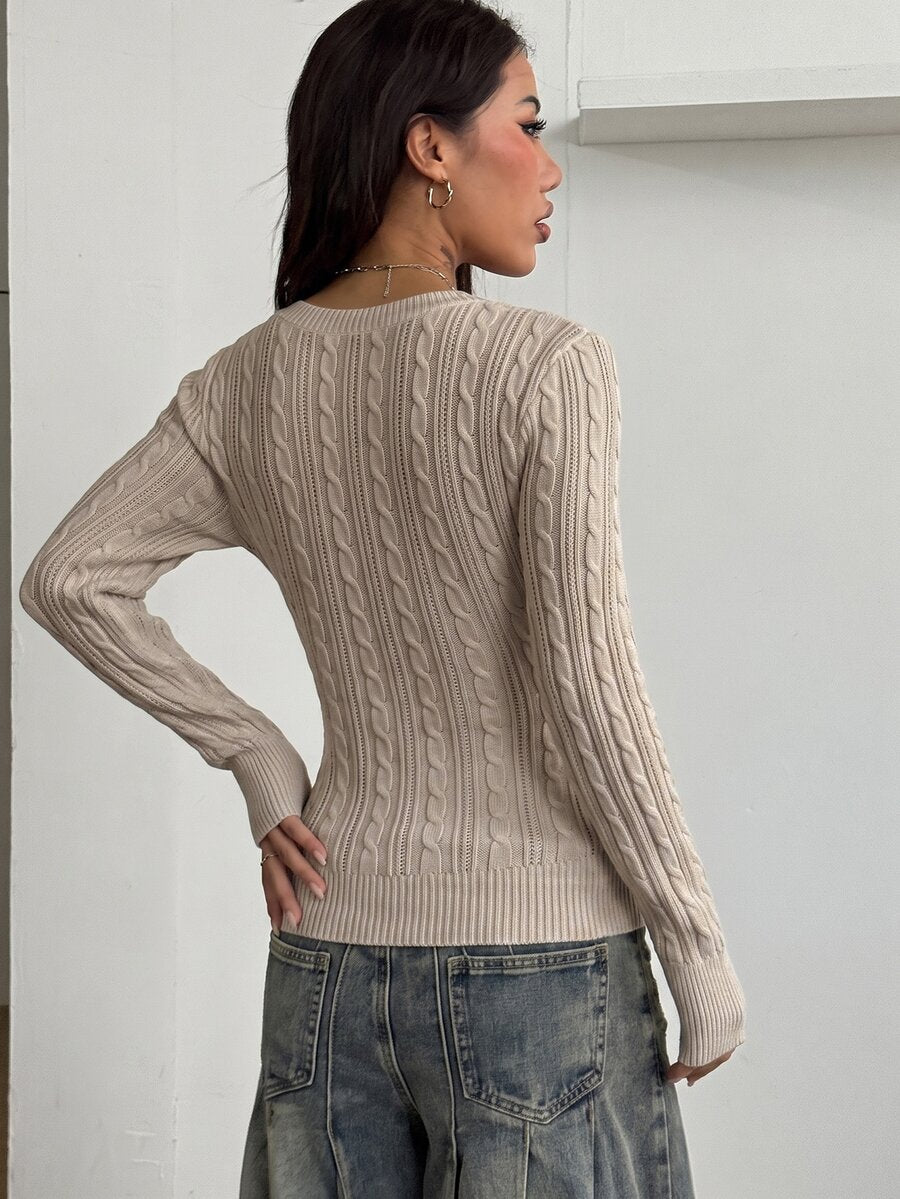 Women's slim fit cable-knit long sleeve sweater featuring a V-neckline and ribbed knit details.
