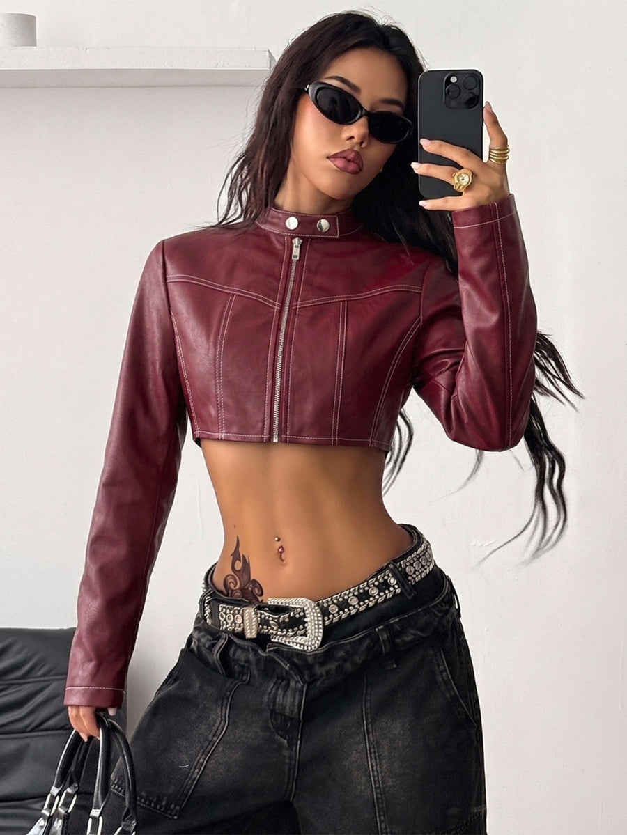 Front view of a women's black cropped PU leather jacket featuring a stand collar, long sleeves, and front zipper closure.