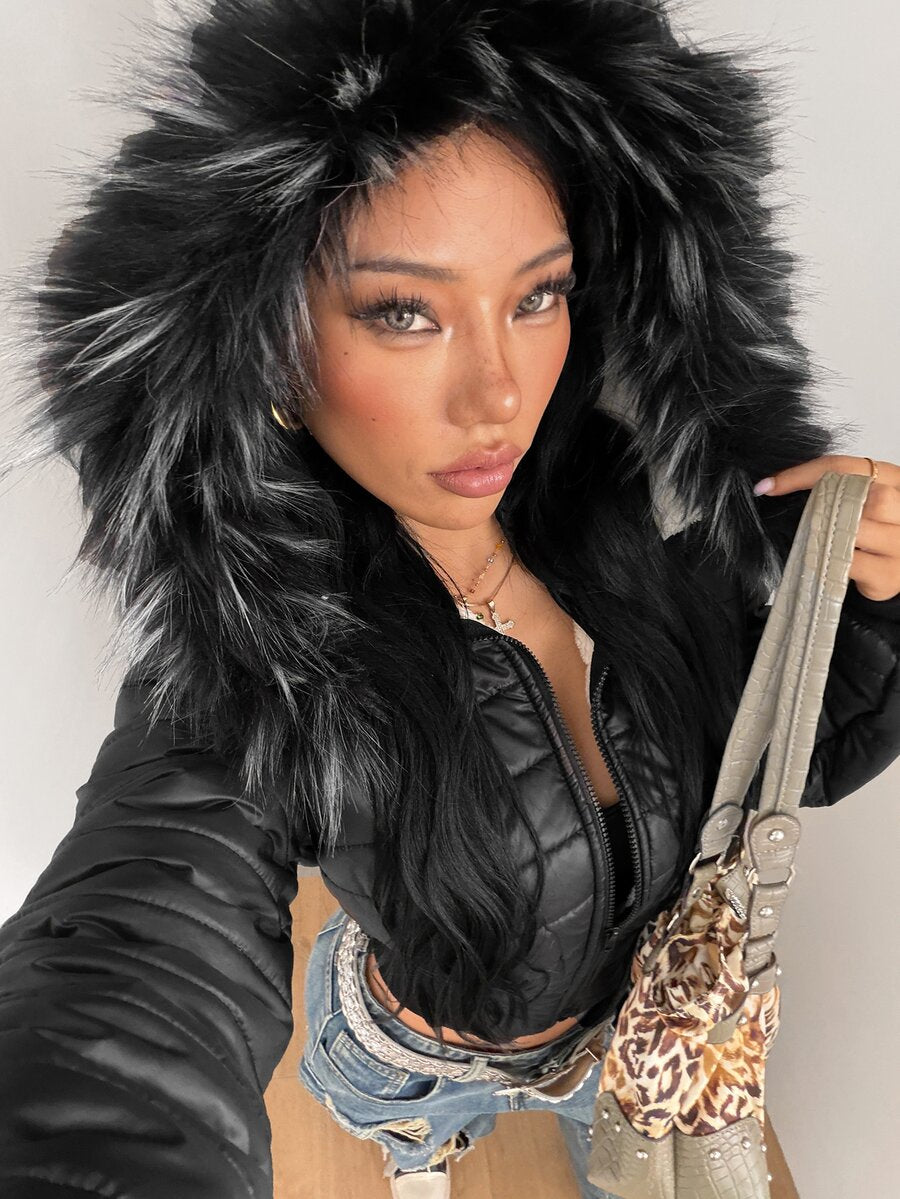 Women's brown cropped puffer jacket featuring a faux fur trimmed hood, front zipper, and ribbed hem.