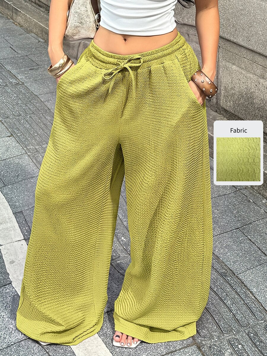 Women's loose fit straight leg lounge pants in textured knit fabric featuring an elastic drawstring waist and side pockets