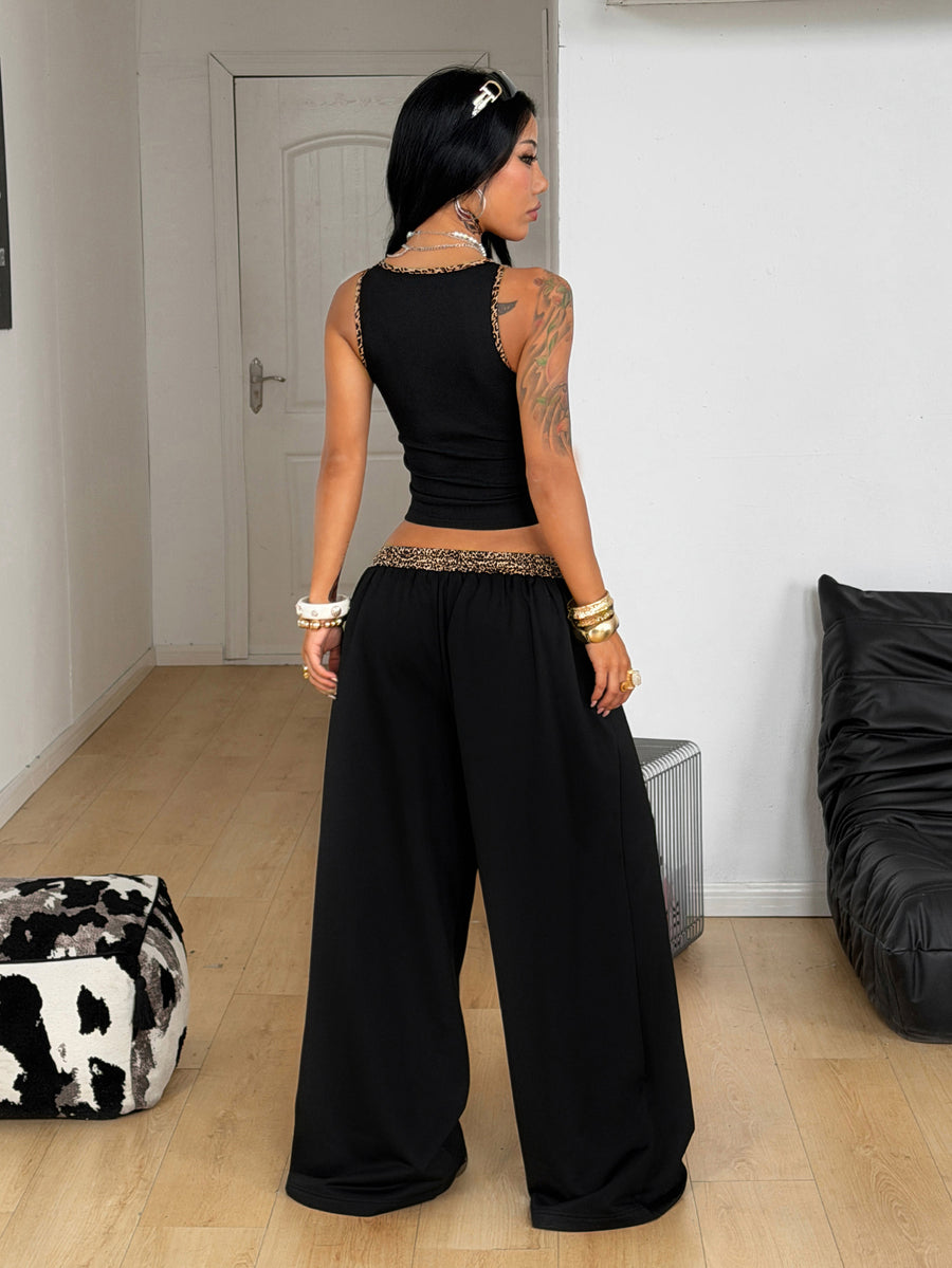 Women's two-piece casual outfit featuring a slim-fit camisole tank top with ruffle trim and button front paired with high-waisted wide leg pants.