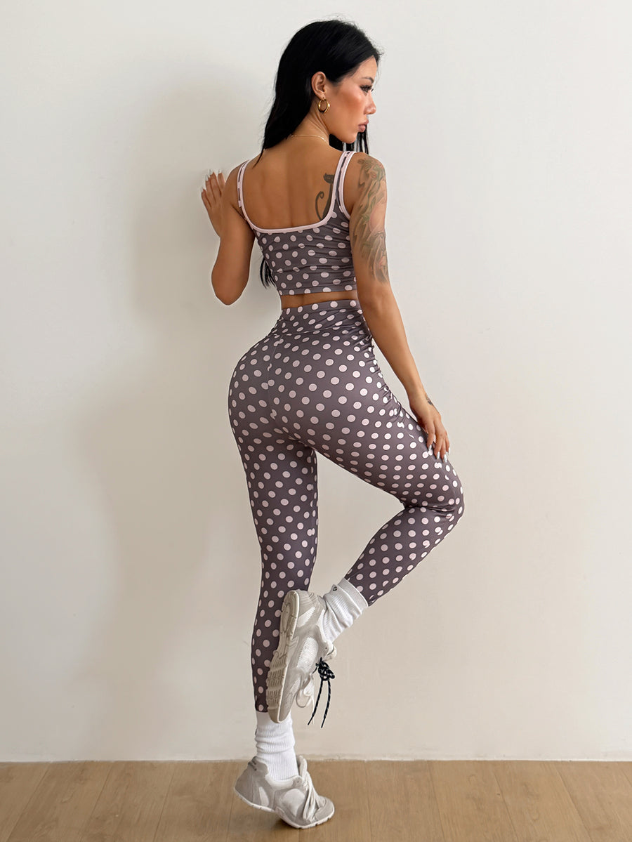 Women's two-piece activewear set featuring a multicolor polka dot backless crop top and matching slim-fit leggings.
