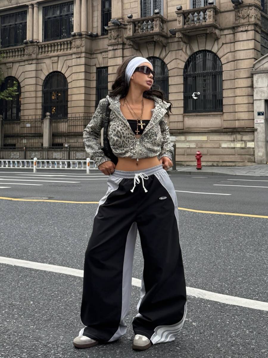 Women's loose fit straight leg pants in black and white with banded texture design, low drawstring waist, and pockets.