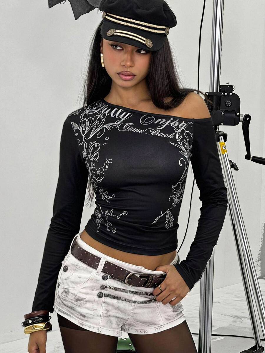 Women's slim fit long sleeve knit top featuring an asymmetrical neckline and grommet eyelet detail