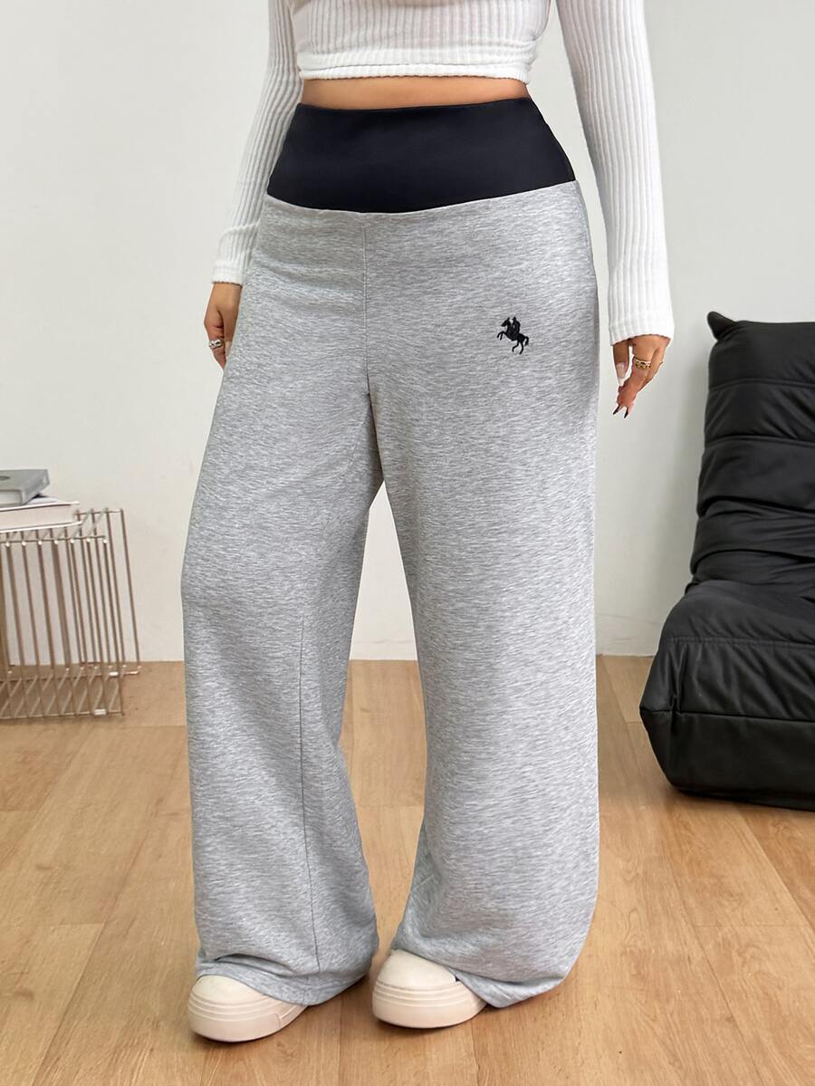 Women's casual straight leg sweatpants featuring a black and white polka dot design with an elastic waistband.