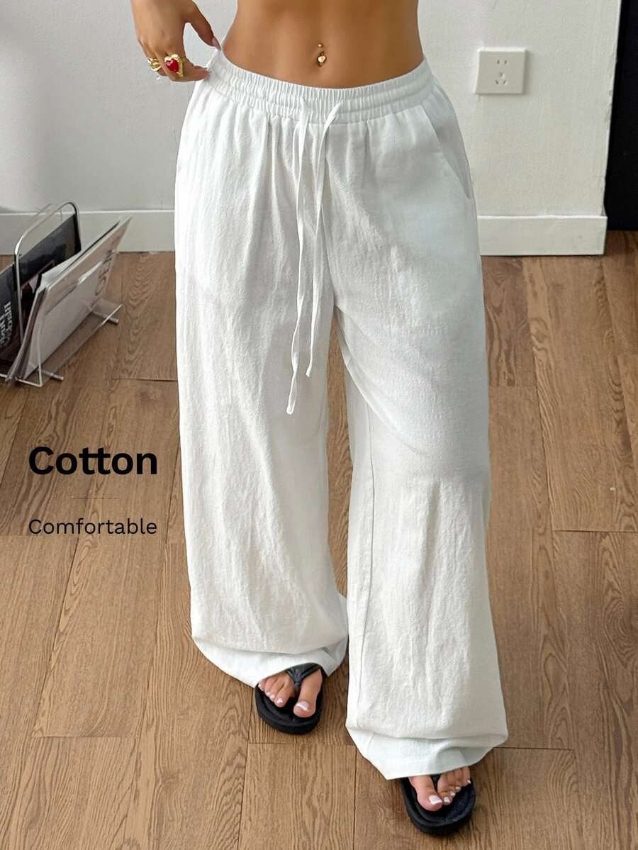 Plus size women's striped loose straight leg cropped pants with pleated detailing and side pockets