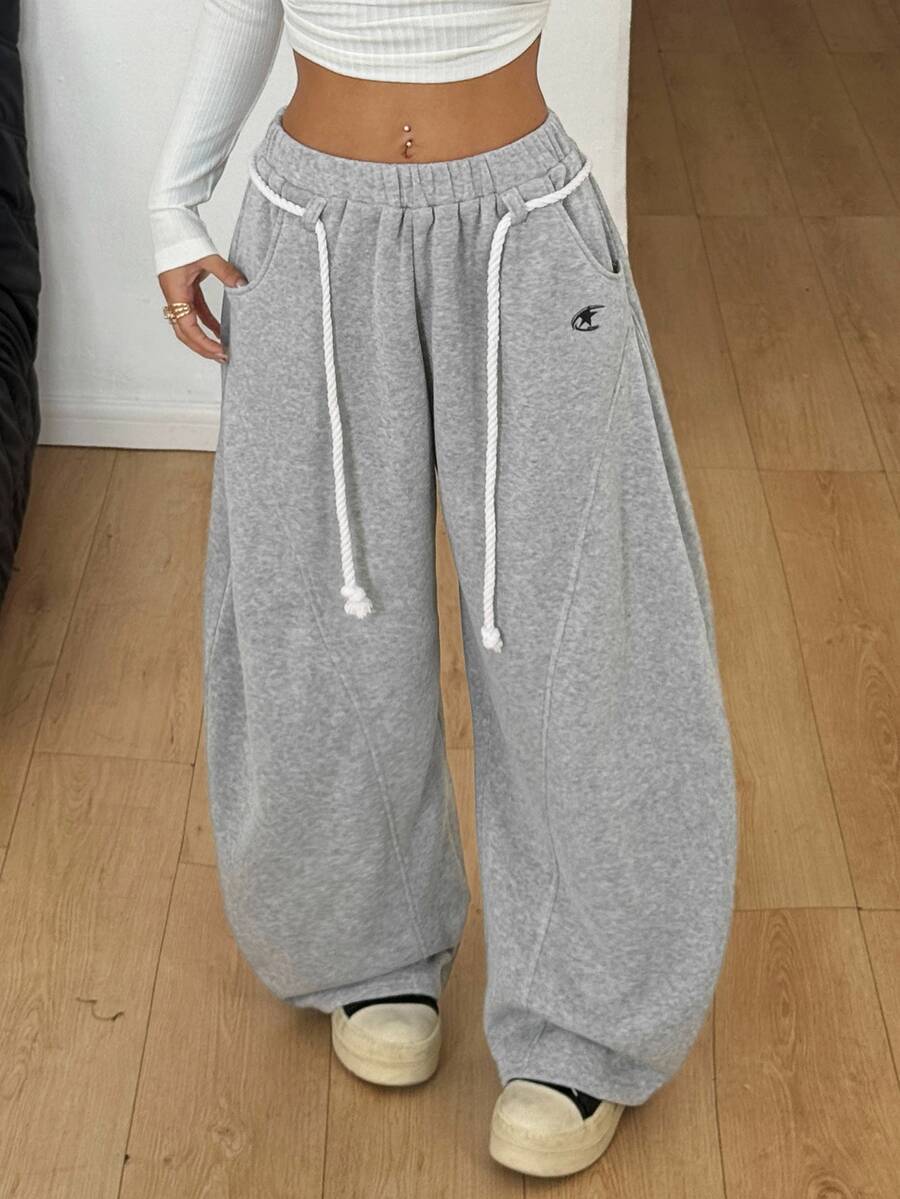 Women's casual grey plaid sweatpants featuring an elastic drawstring waistband, side pockets, and a relaxed loose fit.