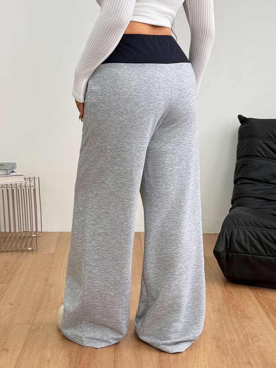 Women's casual straight leg sweatpants featuring a black and white polka dot design with an elastic waistband.