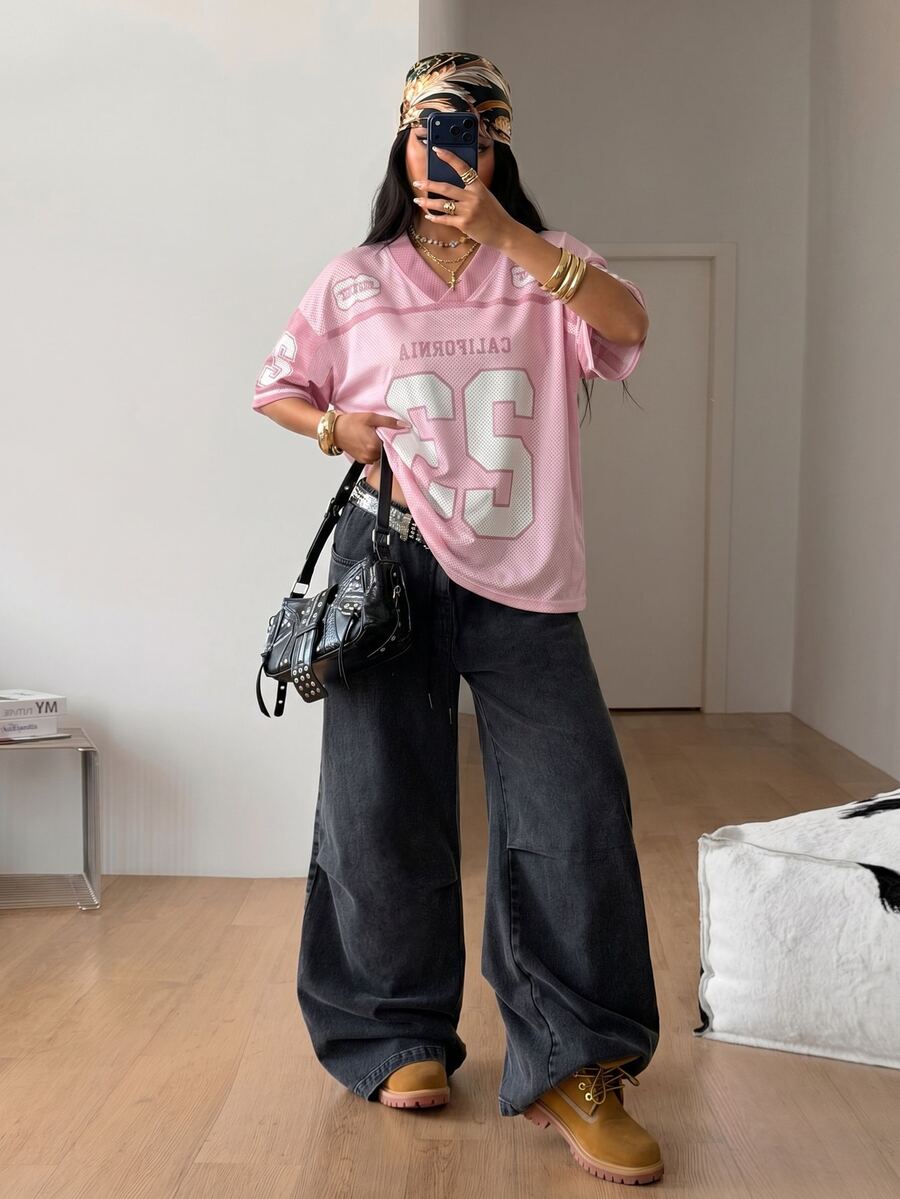Women's oversized short sleeve graphic T-shirt with vintage digital geometric print, V-neck, and asymmetrical hem
