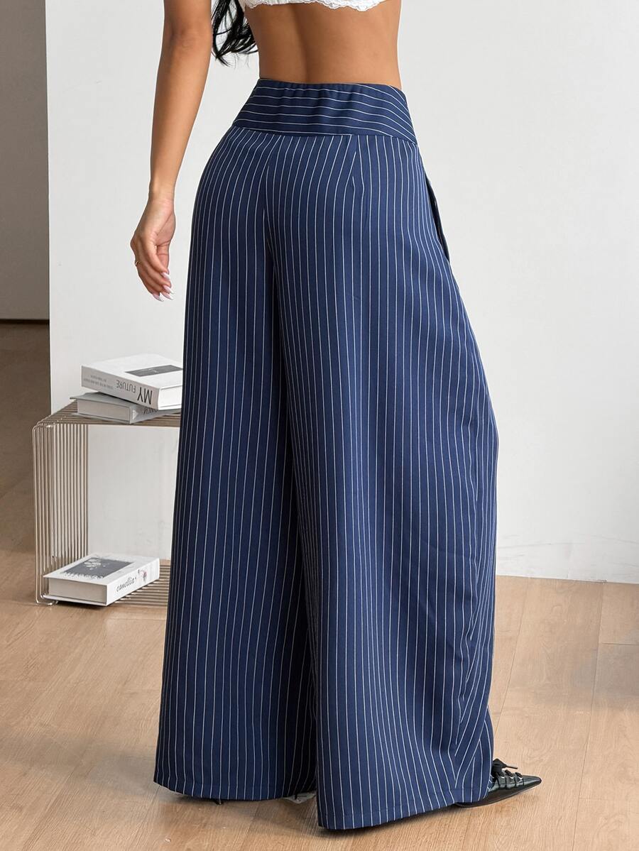 Women's brown striped wide leg pants with a low waist, curved hem, and loose casual fit in woven fabric.