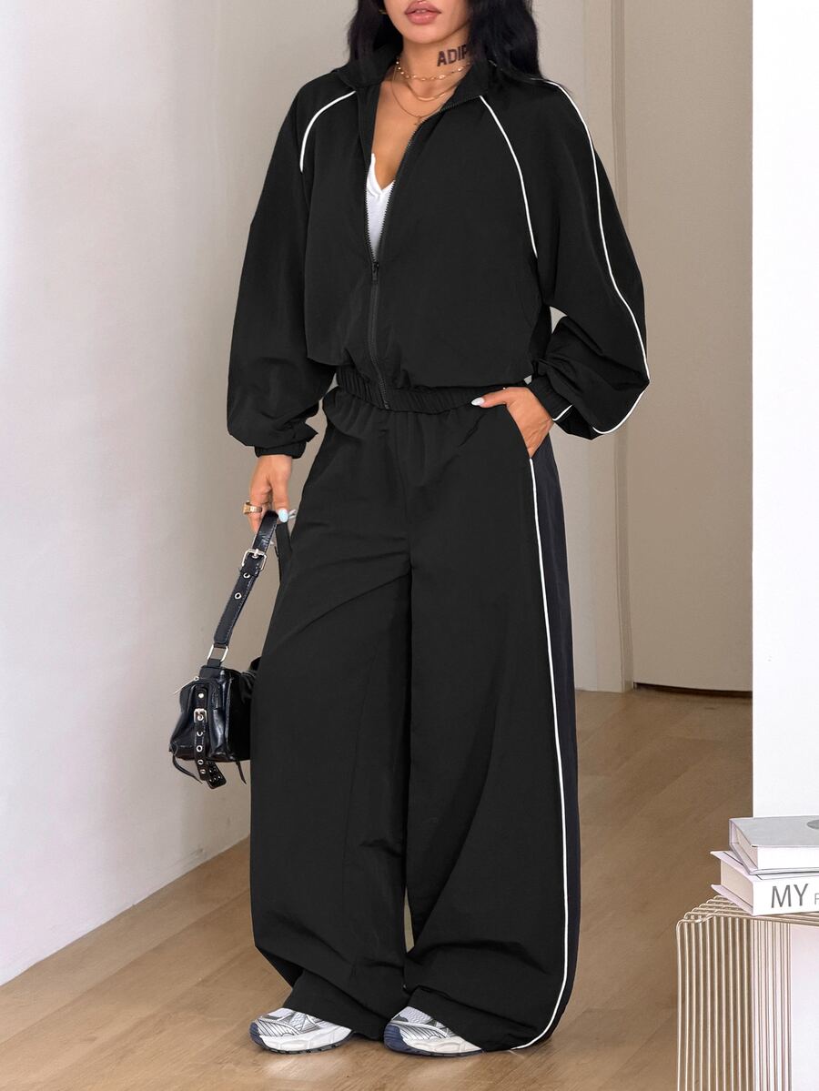 Women's black casual reflective windbreaker sports set featuring a loose stand collar zip jacket and matching unlined pants.