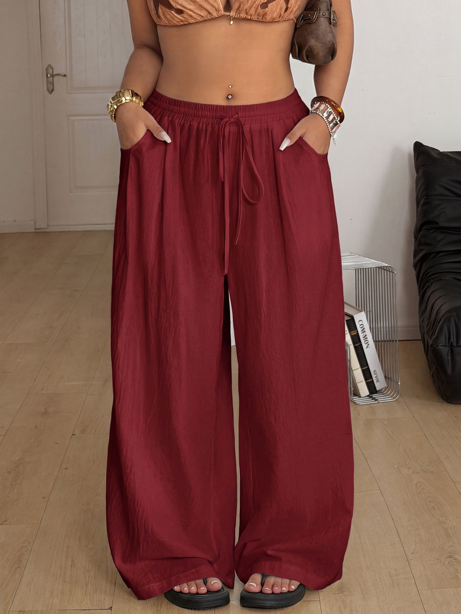Plus size women's striped loose straight leg cropped pants with pleated detailing and side pockets