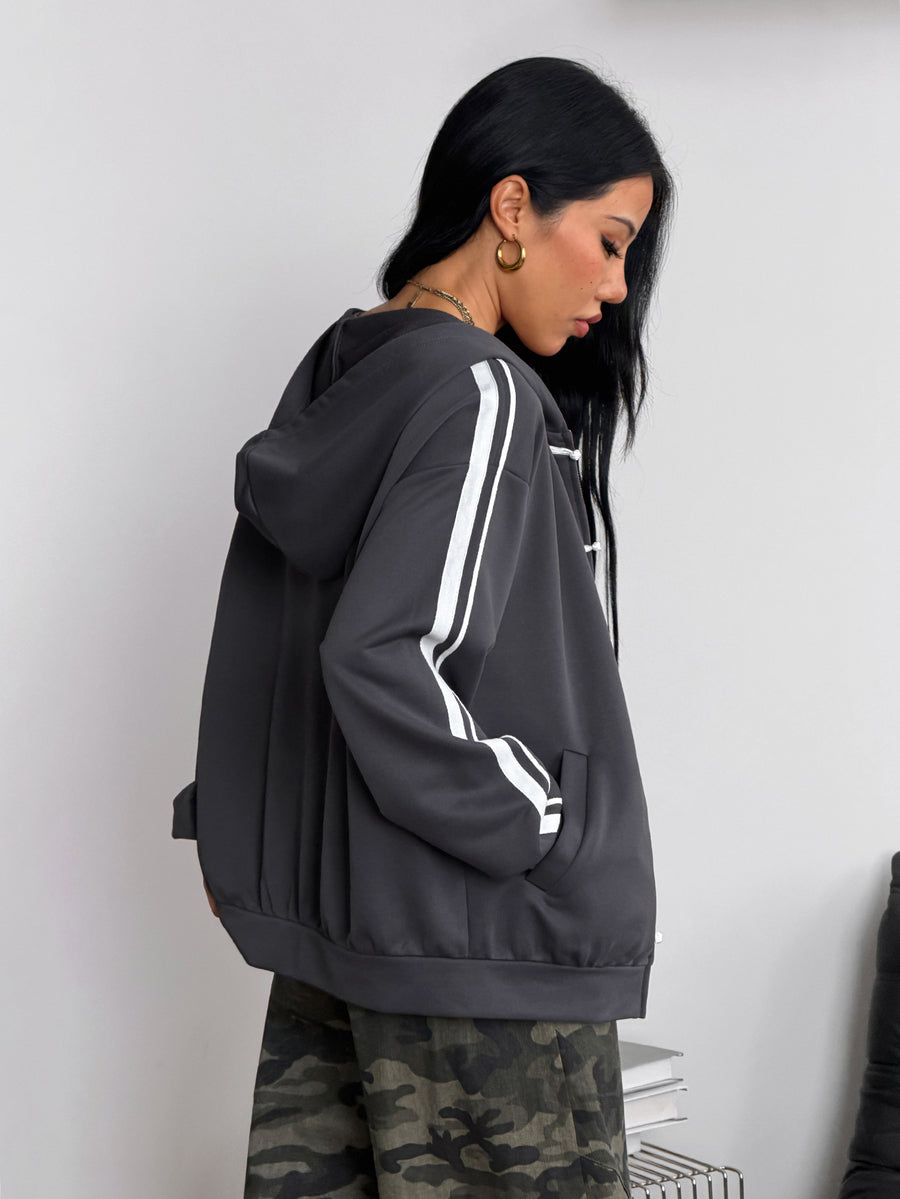 Women's army green camo zip up hoodie with drop shoulder sleeves, front pockets, and drawstring hood