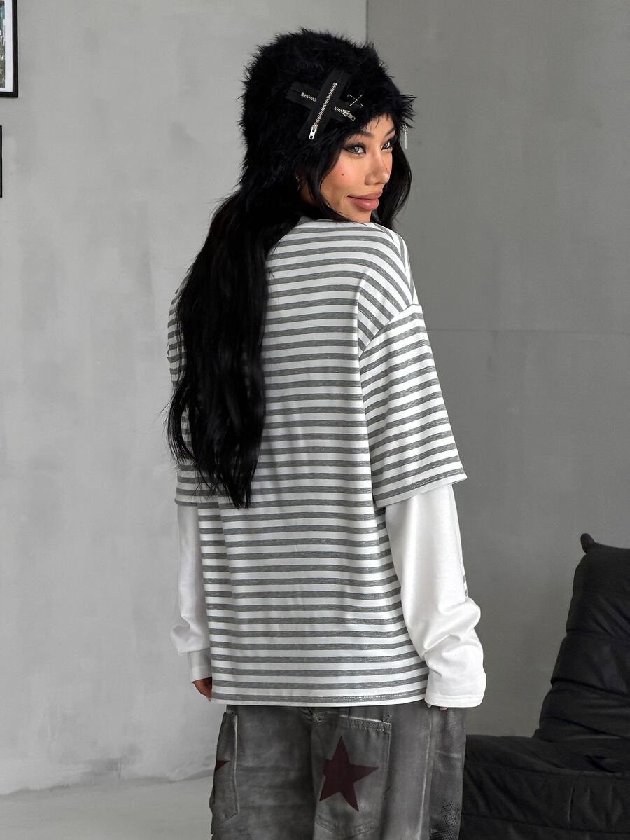 Women's casual graphic long sleeve t-shirt with a round neck, drop shoulder sleeves, and loose relaxed fit.