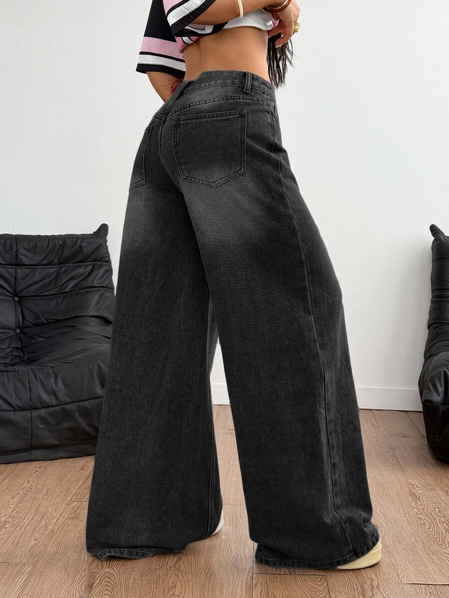 Loose wide leg denim jeans for women featuring a low waist, functional pockets, zipper fly closure, and extra long relaxed fit.