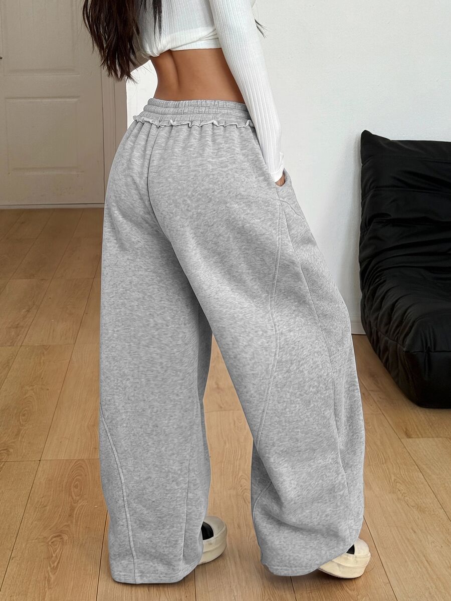 Women's casual grey plaid sweatpants featuring an elastic drawstring waistband, side pockets, and a relaxed loose fit.