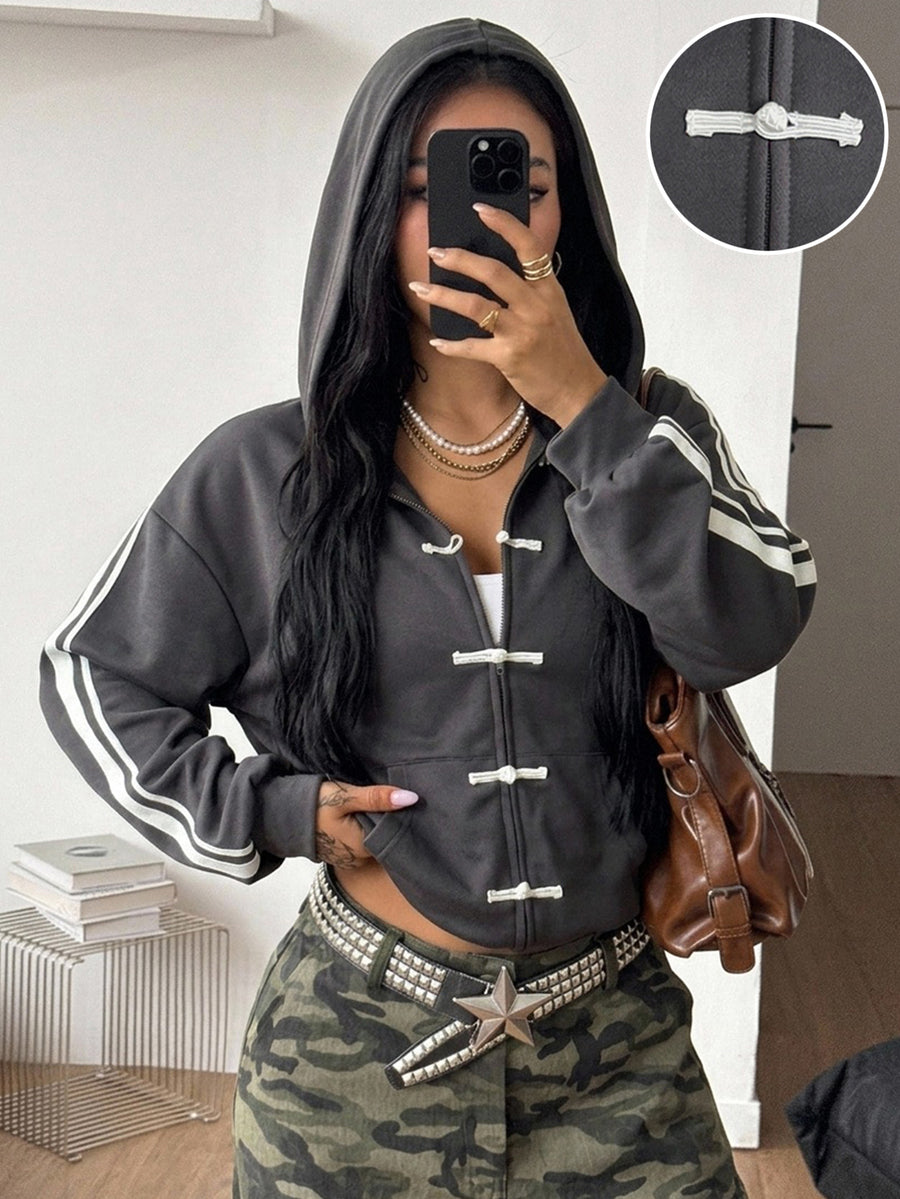 Women's army green camo zip up hoodie with drop shoulder sleeves, front pockets, and drawstring hood