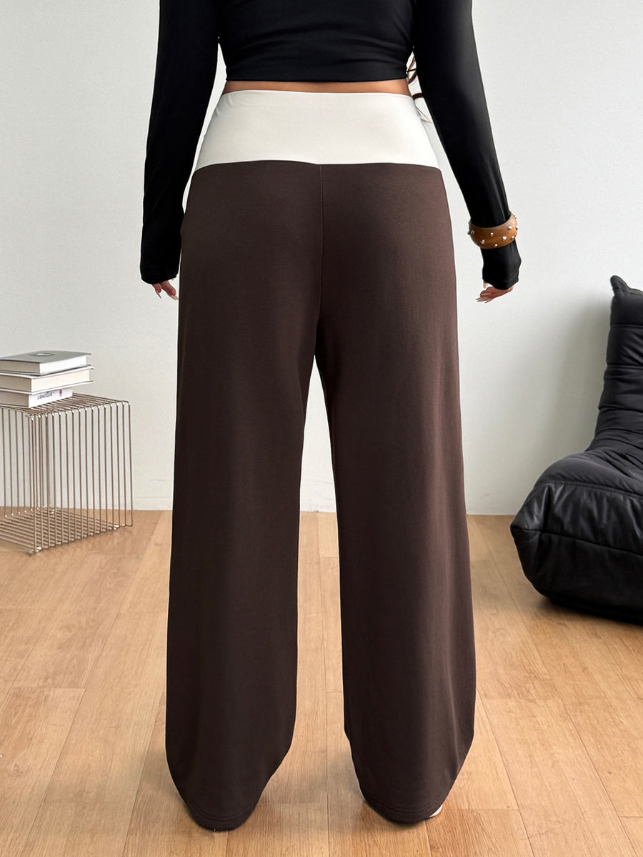 Women's casual straight leg sweatpants featuring a black and white polka dot design with an elastic waistband.