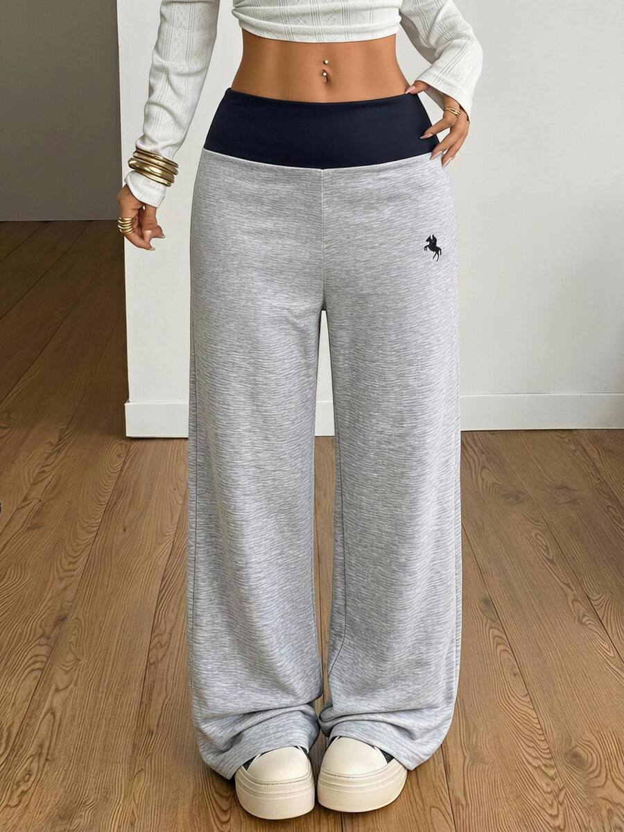 Women's casual straight leg sweatpants featuring a black and white polka dot design with an elastic waistband.