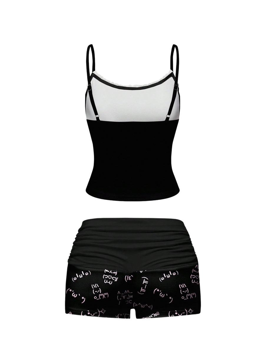 Black two-piece pajama set featuring a spaghetti strap backless camisole and matching ruched shorts.