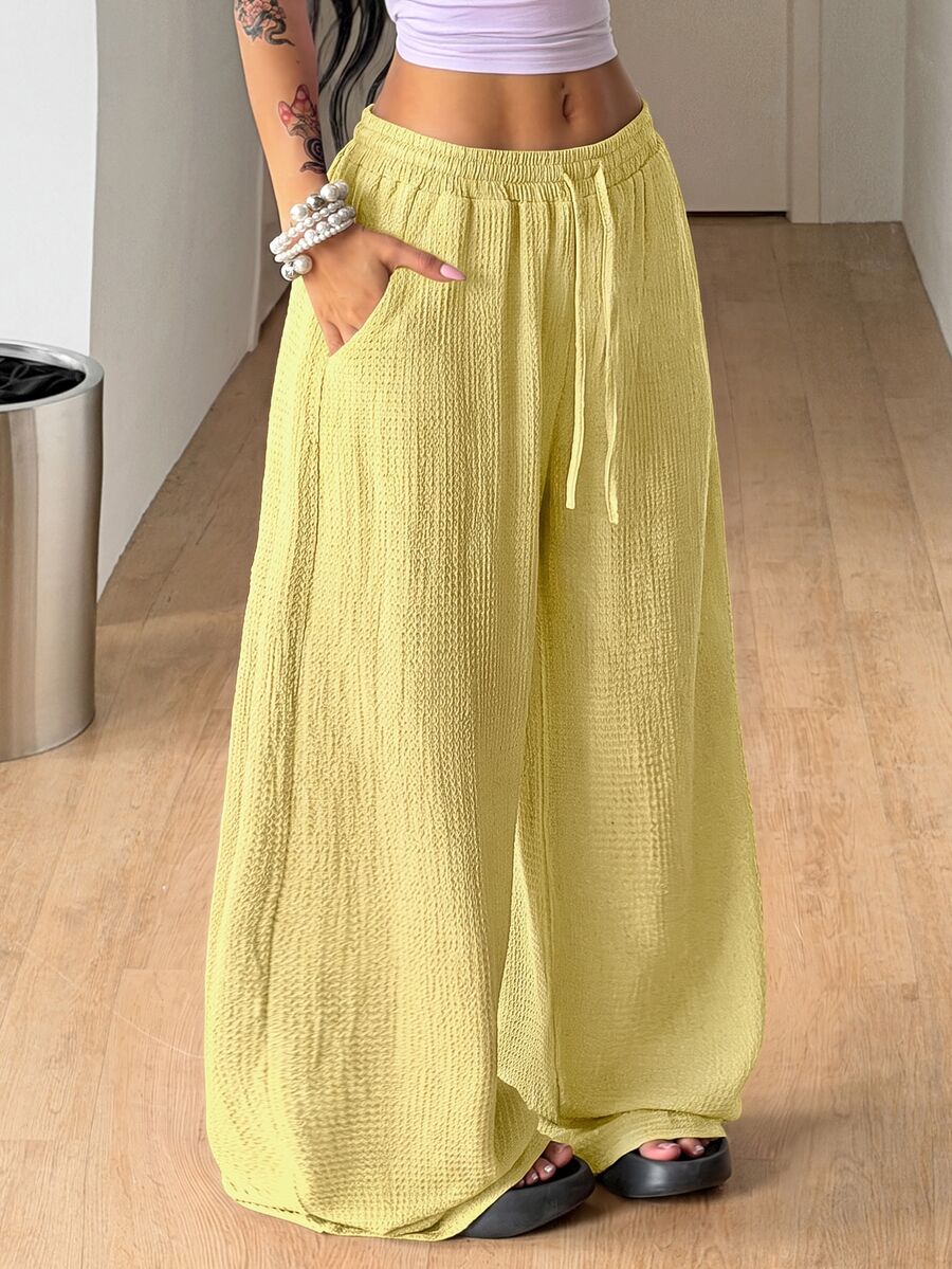 Women's loose fit straight leg lounge pants in textured knit fabric featuring an elastic drawstring waist and side pockets