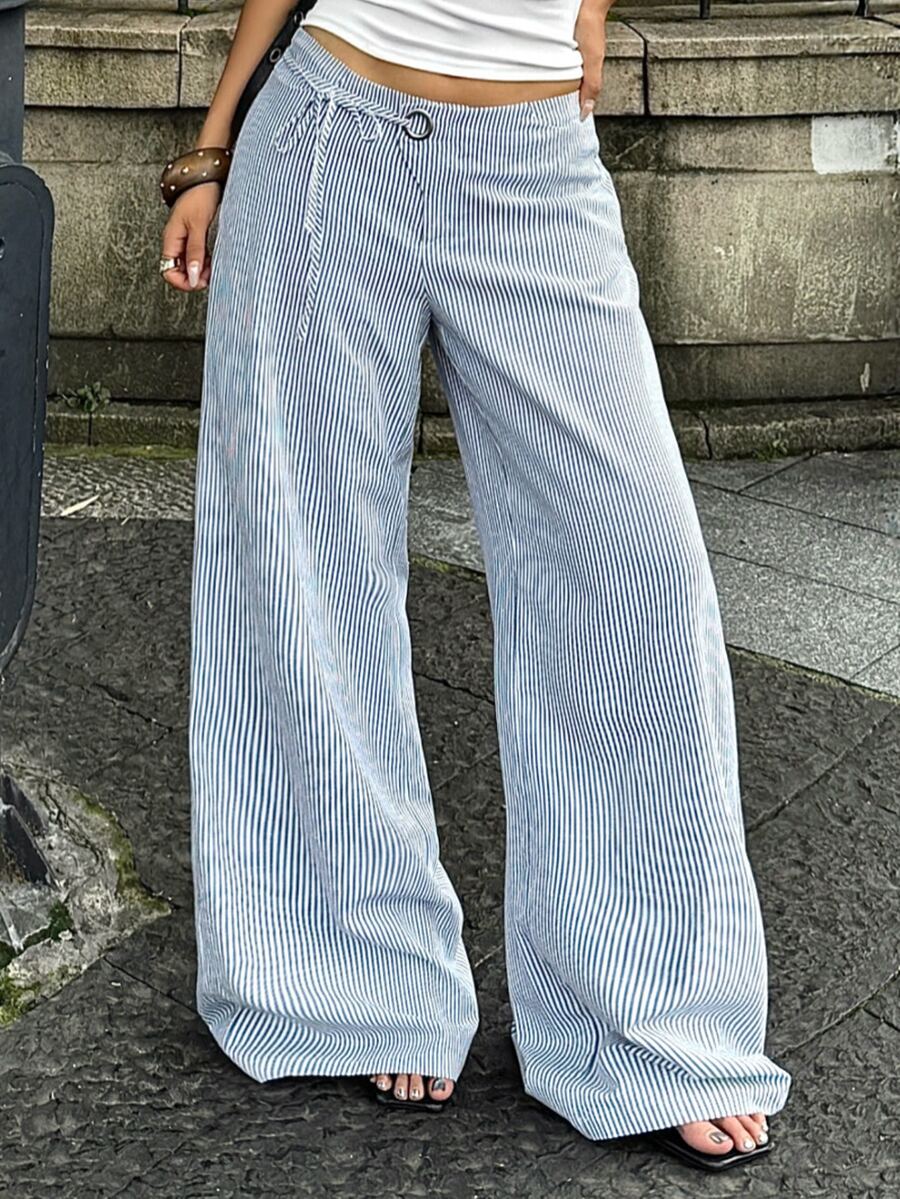 Women's blue and white striped woven wide leg long pants featuring side knot ties and grommet eyelet details.