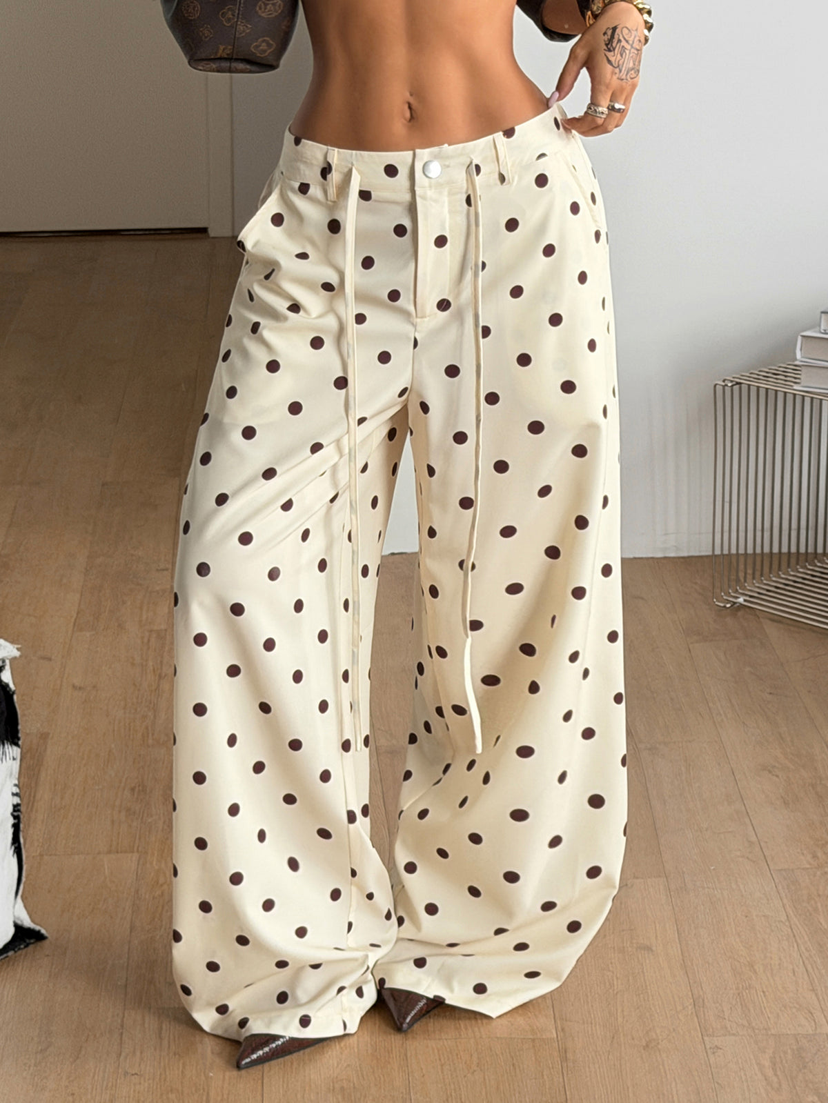 Women's casual straight leg striped woven pants featuring a low waist and zipper fly closure.