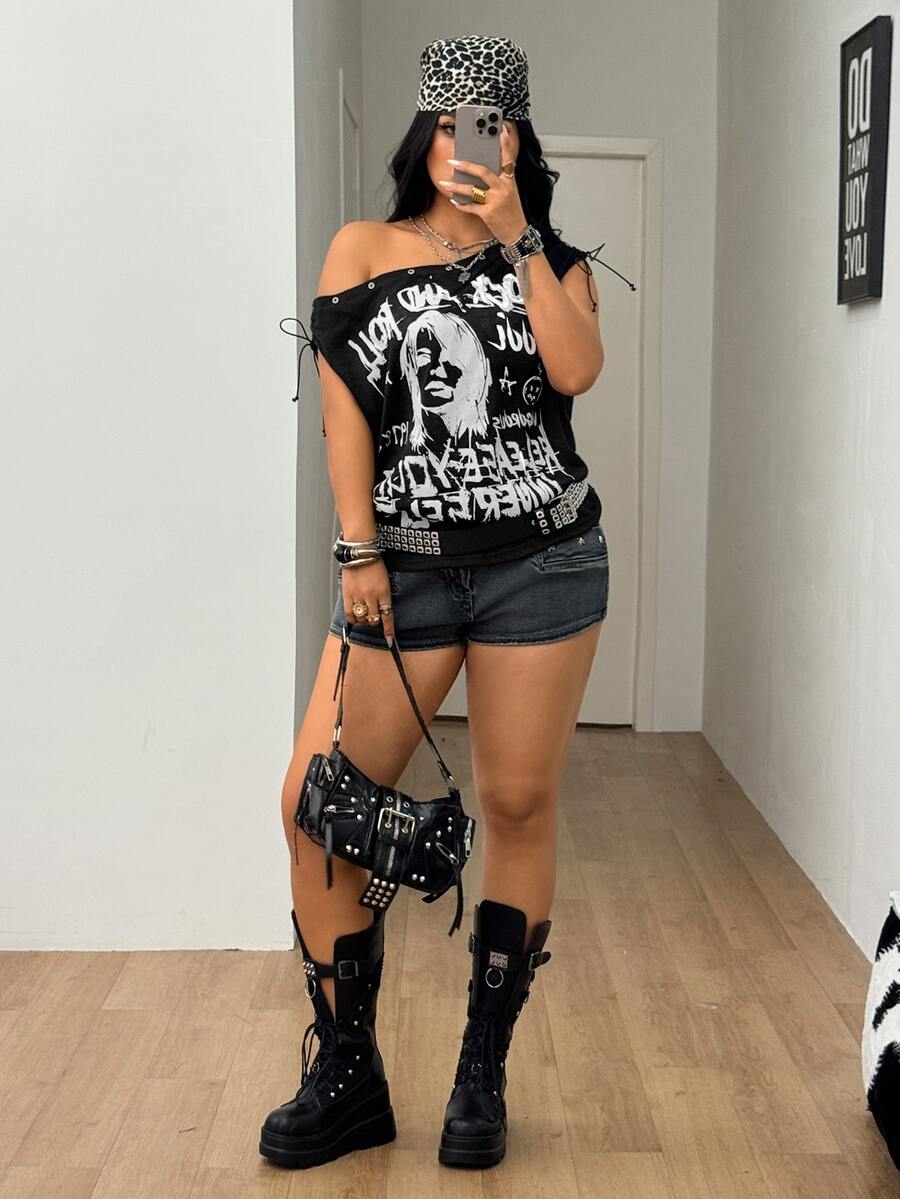 Black plus size cold shoulder graphic T-shirt featuring grommet eyelets, asymmetrical knot detail, and batwing cap sleeves.