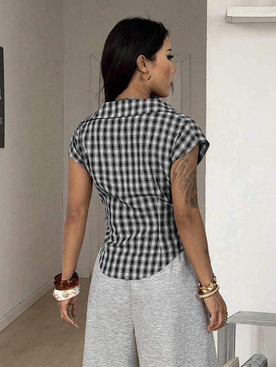 Women's plaid short sleeve shirt featuring a lapel collar and backless design in woven fabric.