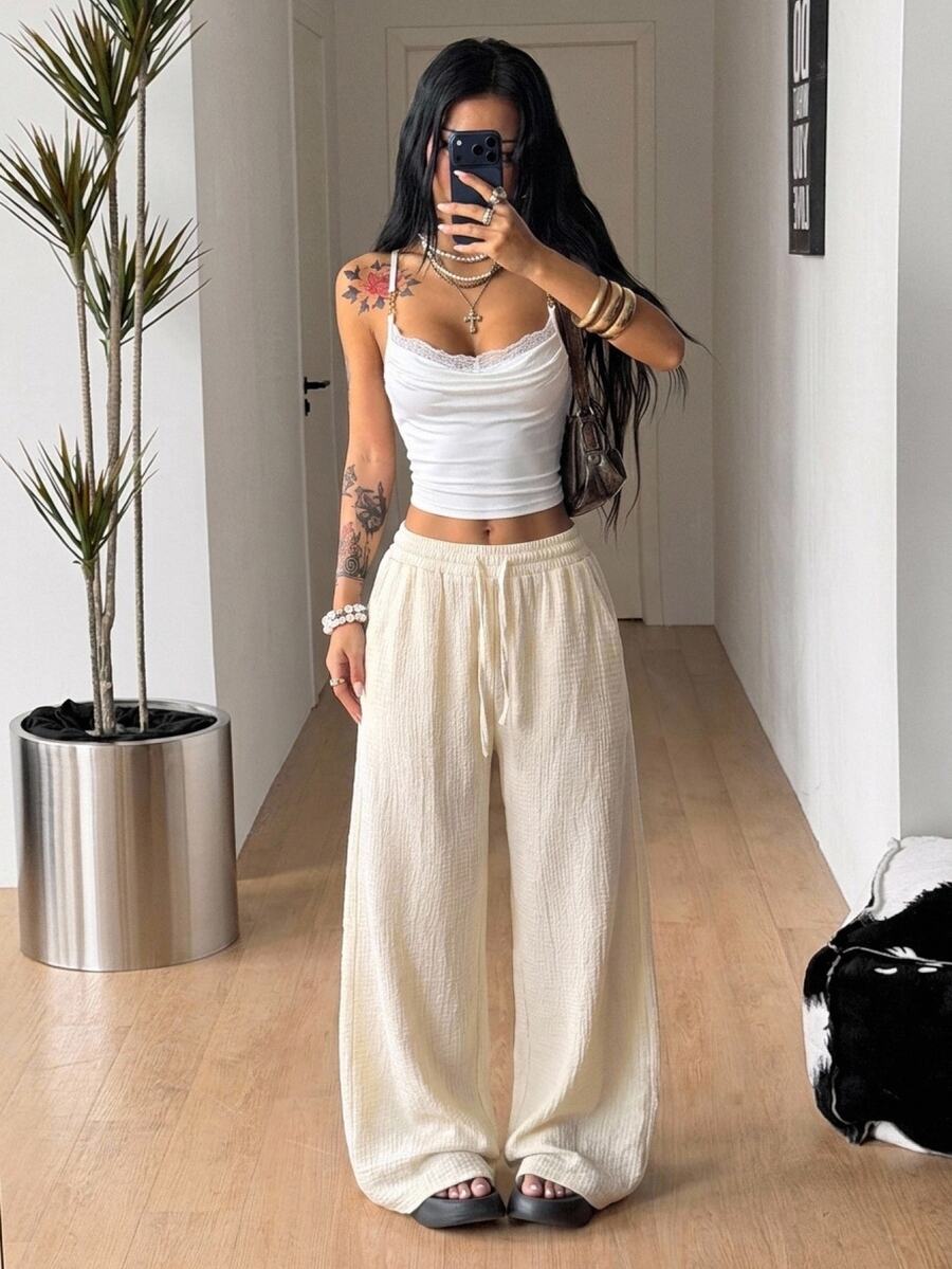 Women's loose fit straight leg lounge pants in textured knit fabric featuring an elastic drawstring waist and side pockets