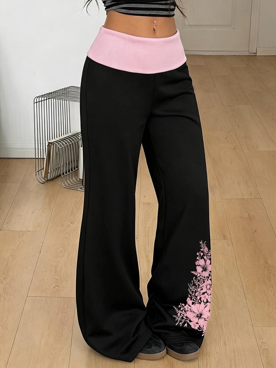Women's black low waist wide leg flare sweatpants with rib-knit texture and contrast binding details.