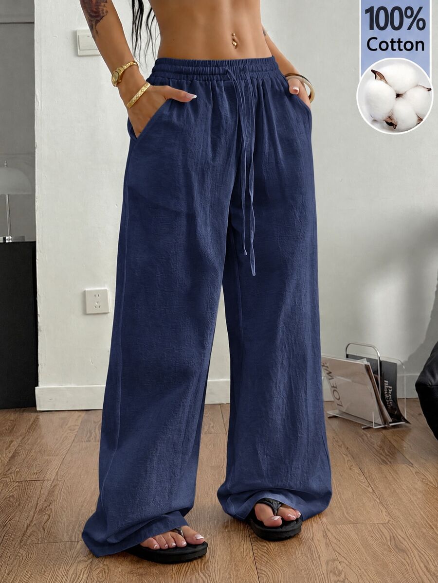 Plus size women's striped loose straight leg cropped pants with pleated detailing and side pockets