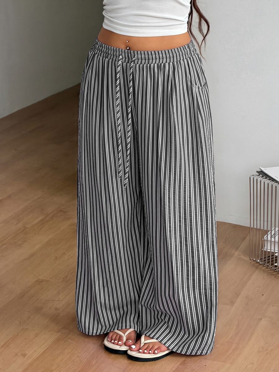 Plus size women's striped loose straight leg cropped pants with pleated detailing and side pockets