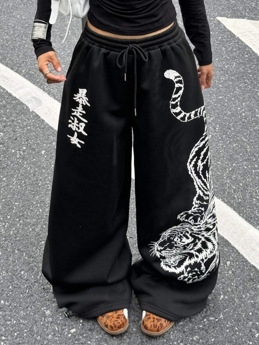 Women's loose fit wide leg graphic sweatpants in light grey with an elastic drawstring waistband