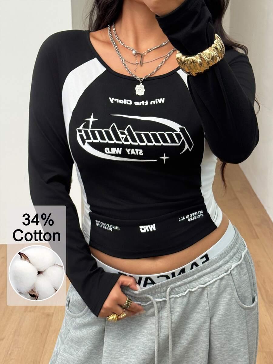 Women's plus size black and white colorblock long sleeve t-shirt with raglan sleeves and scoop neckline.