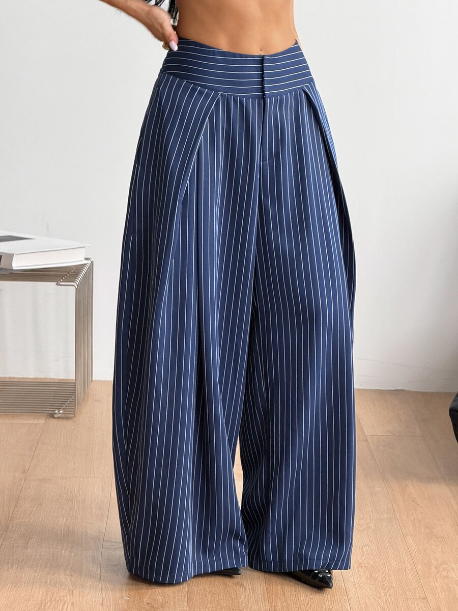 Women's brown striped wide leg pants with a low waist, curved hem, and loose casual fit in woven fabric.