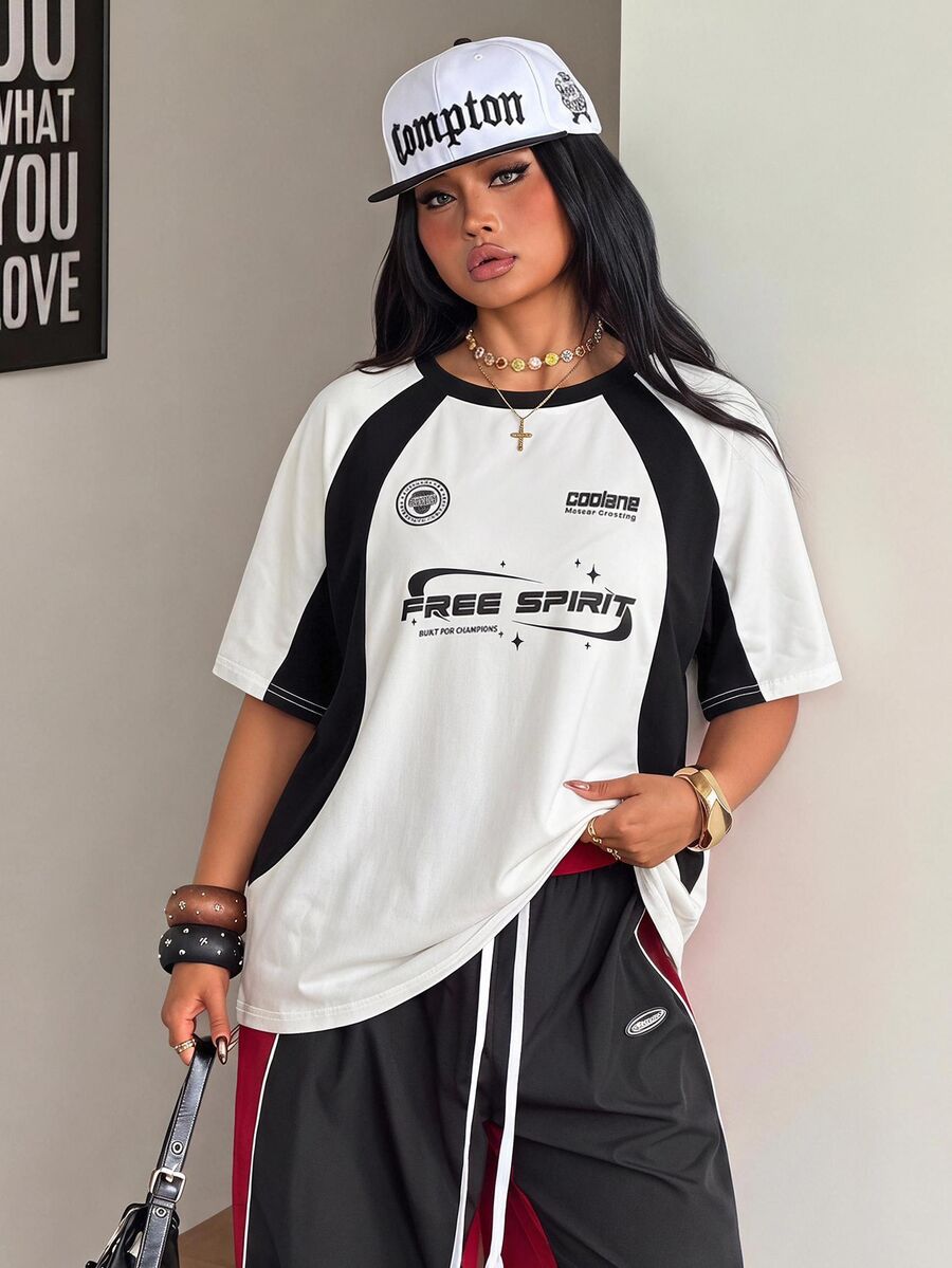 Unisex plus size oversized jersey t-shirt in brown featuring a round neck, short raglan sleeves with contrast binding, and a front letter graphic print.