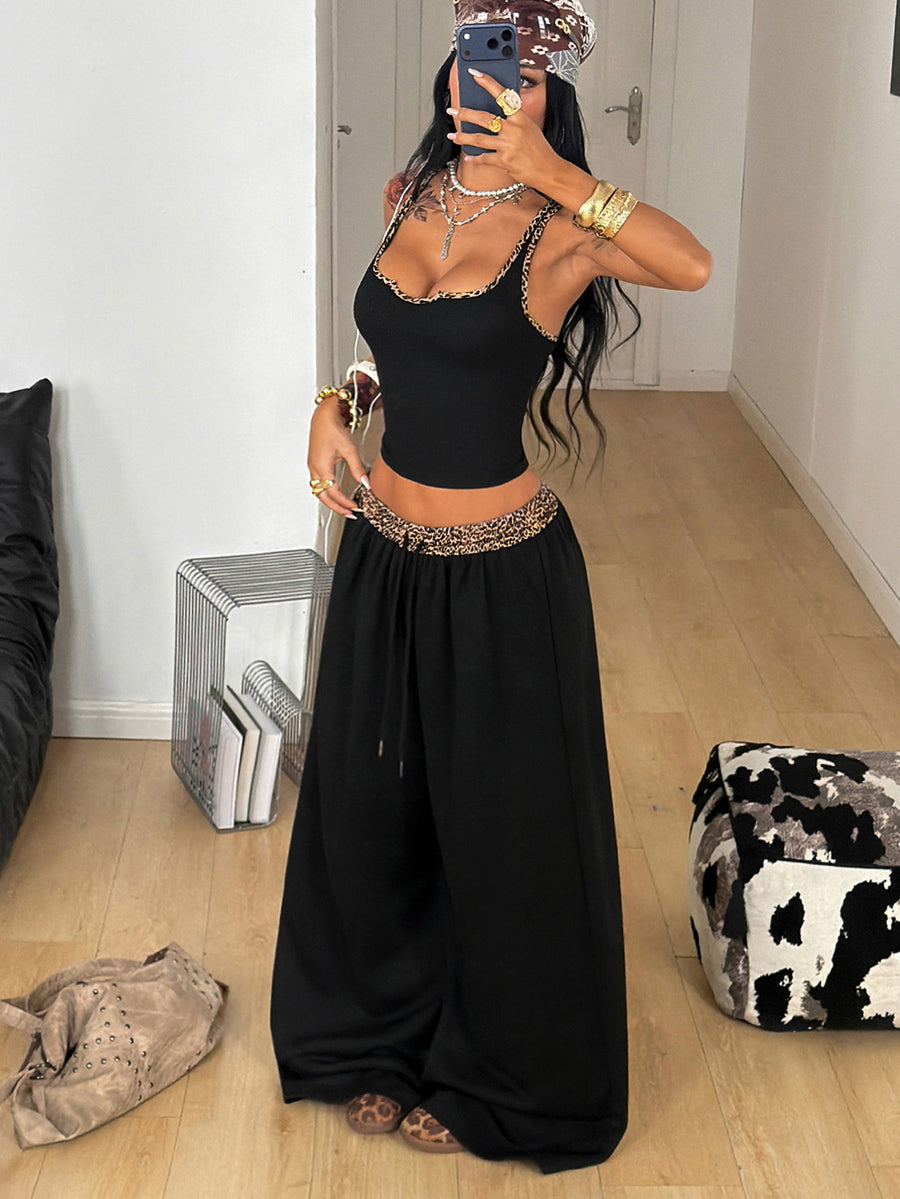 Women's two-piece casual outfit featuring a slim-fit camisole tank top with ruffle trim and button front paired with high-waisted wide leg pants.