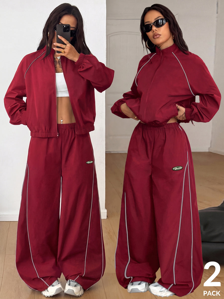 Women's two-piece sporty casual tracksuit set featuring a stand collar zip-up jacket with contrast binding and matching loose parachute pants.