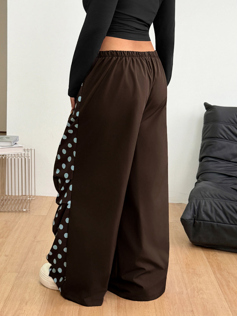 Women's high waist wide leg pants in black featuring leopard print patchwork details and an elastic drawstring waistband.